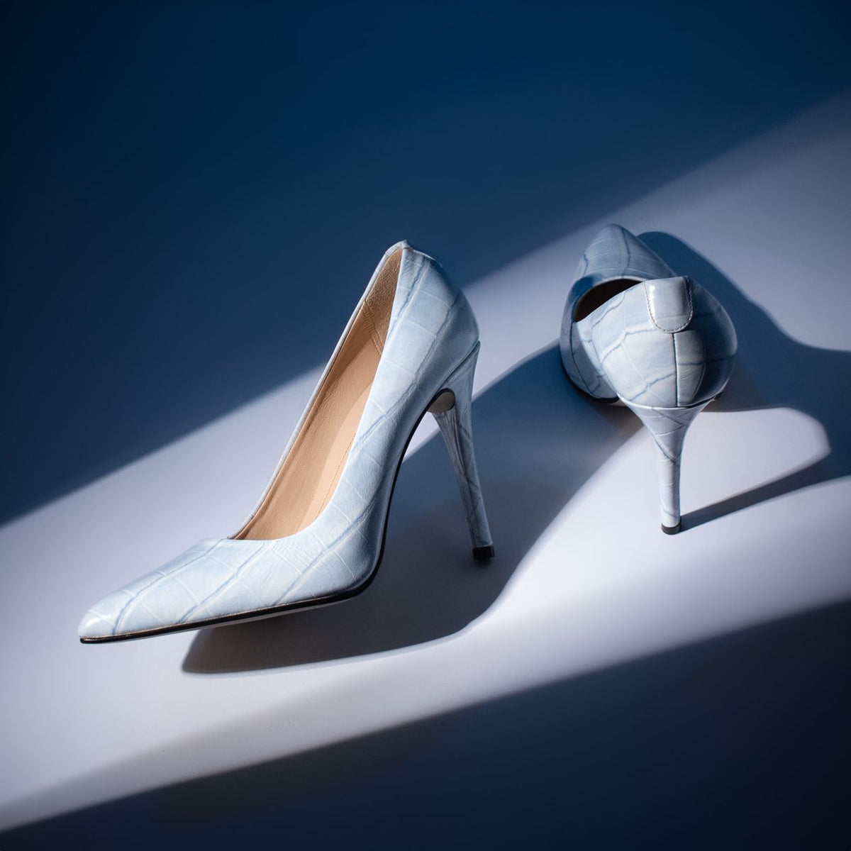 White croc-embossed stilettos